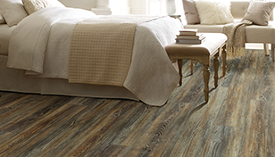 luxury vinyl solid core floor with multi-stained rustic hardwood look in bedroom.
